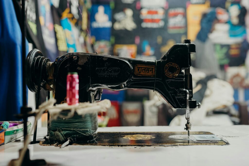 Close-up of a vintage sewing machine in a vibrant Indian market setting, showcasing cultural heritage.